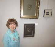 Photo of the artist by several of her metal collages