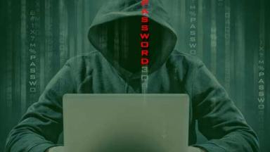 Faceless hacker with a laptop and scrolling text reading password.