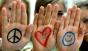 Photo of girls with marker drawings on their hands: peace, a heart, smiley face