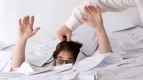 man trying to lift a person out of a large pile of paper sheets 